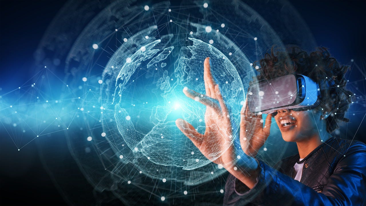 A person wearing a VR headset reaches into a projected, wireframe globe.