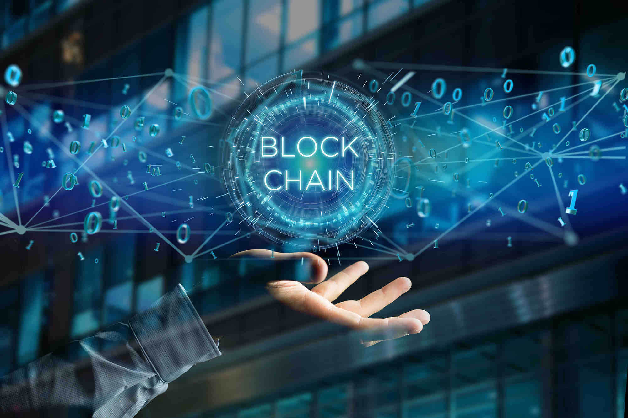 A holographic blockchain network diagram held above an open hand.