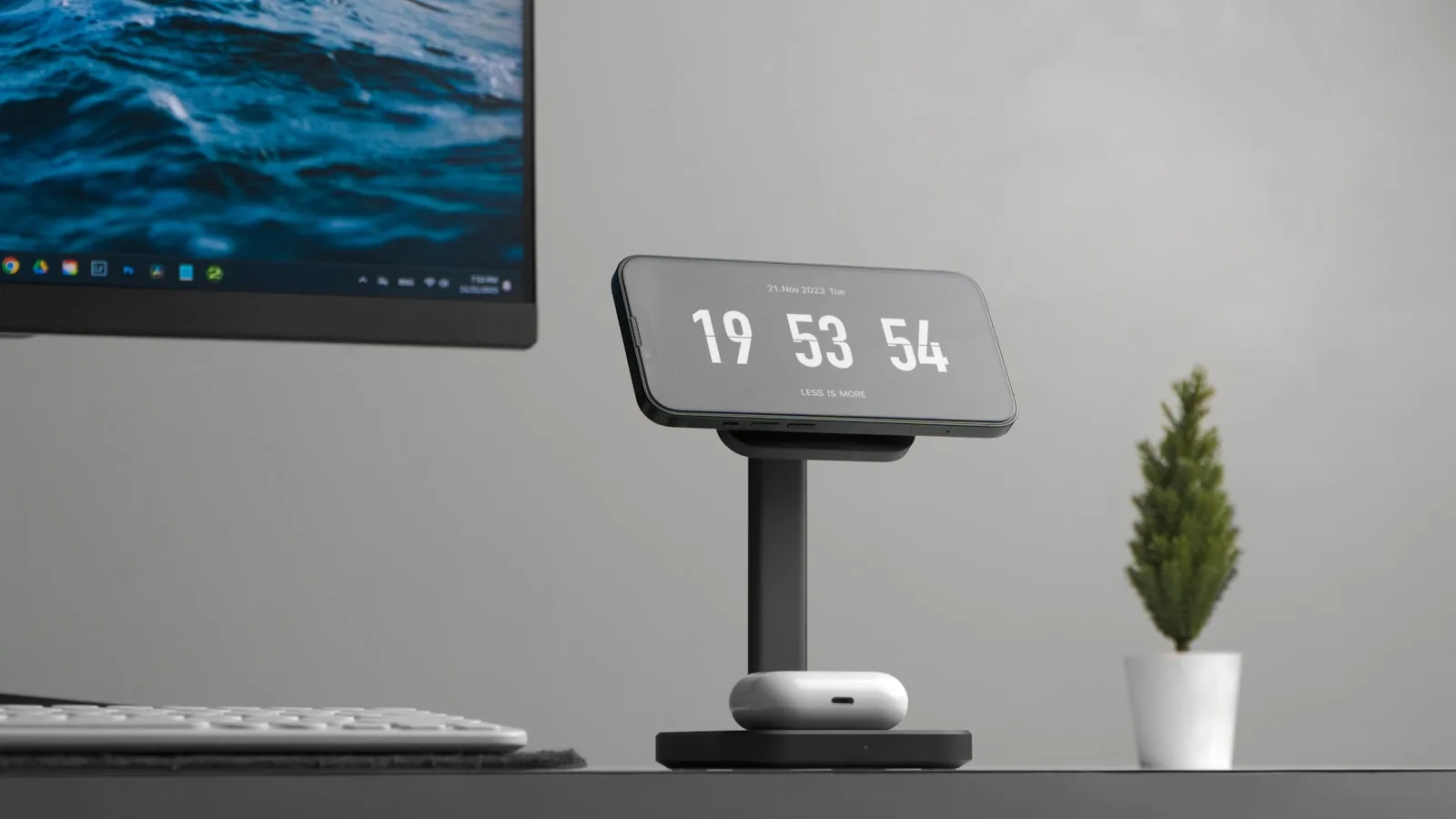 A phone on a minimal desk stand displaying a large digital clock
